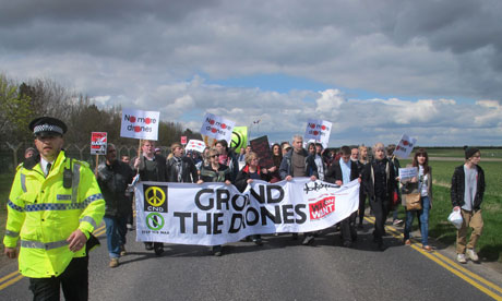 Protesters march to the perimeter fence of RAF Waddington, Lincolnshire